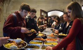 Third and fourth year economics majors load their plates at the annual Undergraduate BBQ
