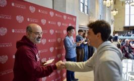 Professor Victor Lima shakes hands with prize winner while Professor Kotaro Yoshida emcees the annual Undergraduate BBQ